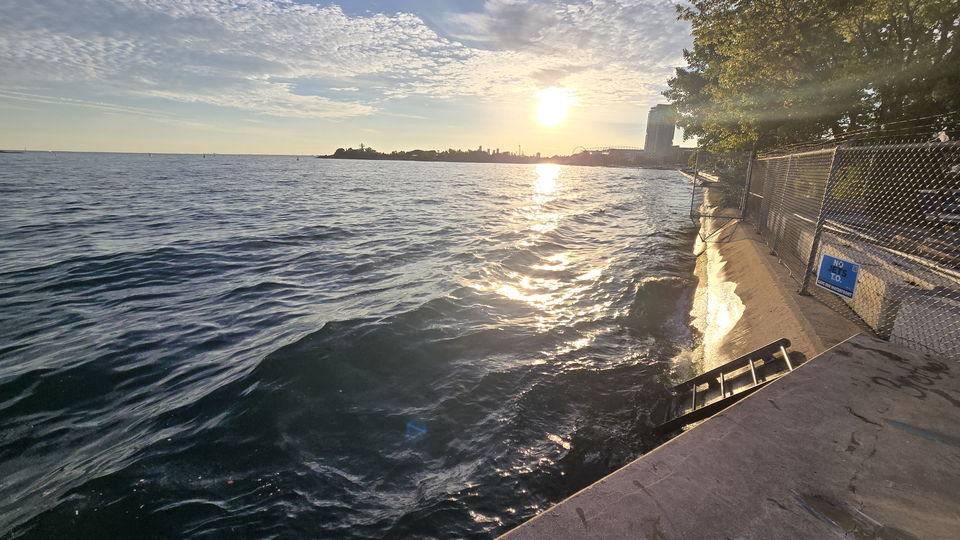 Low sun over open water at the west end of the pier