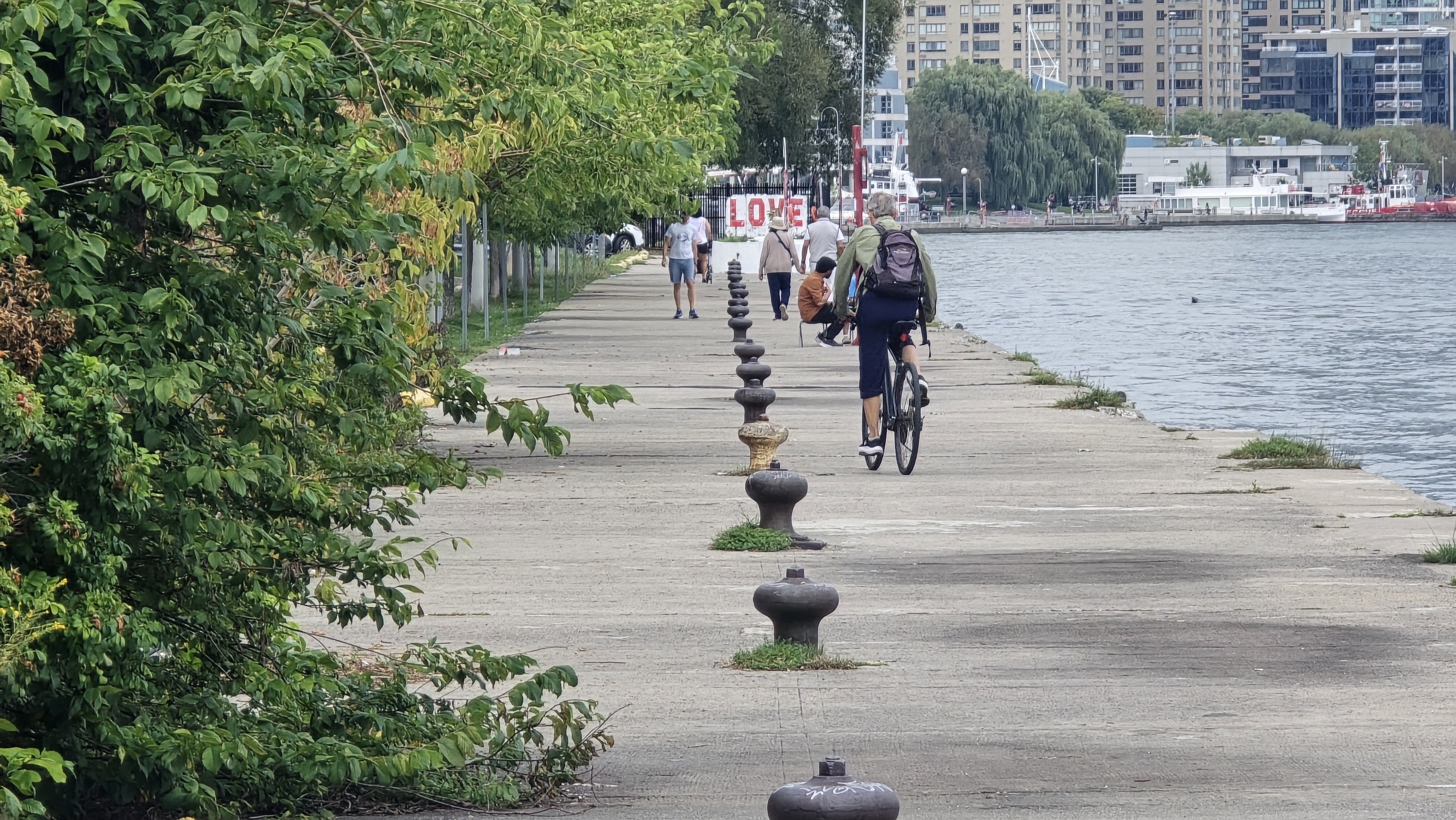 The LoveQuay pier stretching west into Lake Ontario at dusk, mooring bollards lining the deck